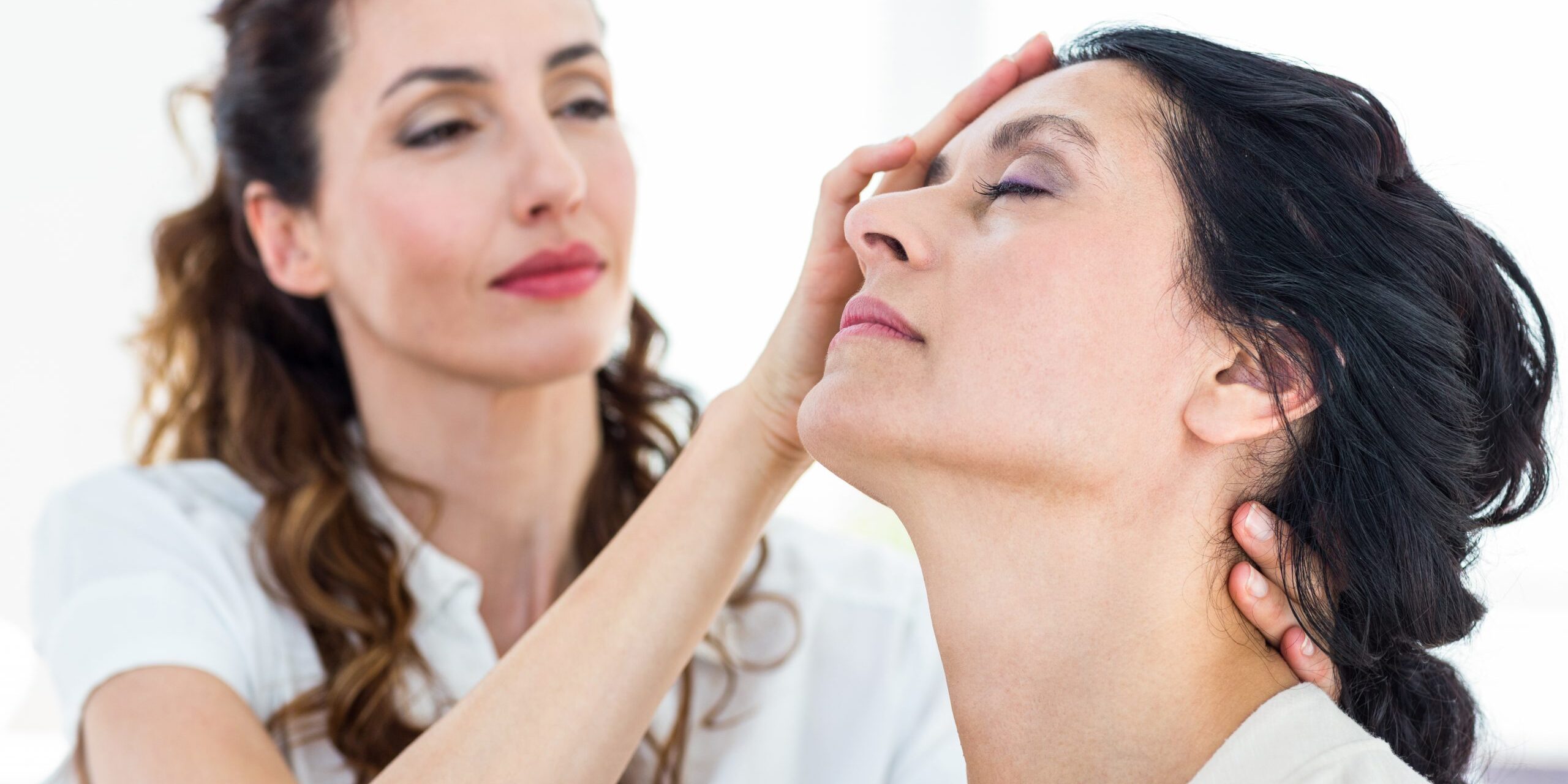 Therapist hypnotizing her patient on white background